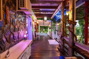 a porch of a house with purple lights on it at Mare MaravellaThis is the Live in Tordera