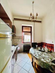 a kitchen with a table and a dining room at Apartman Katedrala in Sarajevo