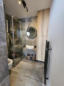 y baño con ducha acristalada y lavamanos. en Apartman Katedrala, en Sarajevo