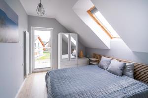 Posteľ alebo postele v izbe v ubytovaní Apartamenty Eksploris II