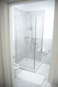 a white bathroom with a shower and a toilet at Nordic Residence 1 in Suceava