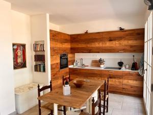 a kitchen with a wooden wall and a wooden table at Podere Terraviva in Riparbella