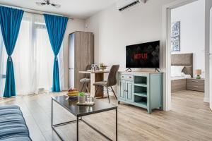 a living room with a blue cabinet and a tv at ARI Olive Apartment near Atrium & AFI Mall in Arad