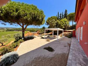 un jardín con una tienda y un árbol en Podere Terraviva, en Riparbella