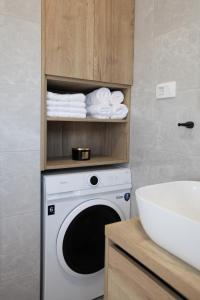 a washing machine in a bathroom next to a sink at Apartment Sweet Dreams in Trogir