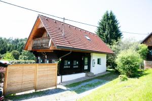 a house with a wooden fence in front of it at Winzerhaus Rose 