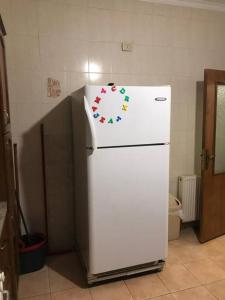 a white refrigerator with a sticker on the top of it at 2 Bed Room Apparment in Amman - Der Ghbar in Amman