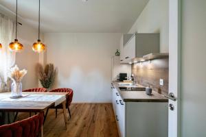 a kitchen and dining room with a table and a dining room at Winzerhaus Rose in Wald in der Weststeiermark