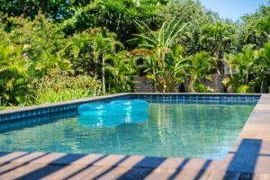 a swimming pool with blue buoys in the water at North Shore Garden Studio in Haleiwa