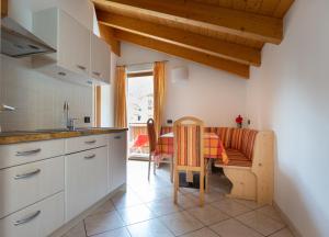 a kitchen with a table and a dining room at Chalet Loredana in Livigno