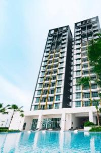 a large building with a swimming pool in front of it at JOVIAL Modern Cozy Suite `Metropol BM BandarPerda in Bukit Mertajam