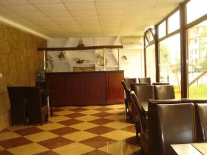 a dining room with chairs and a checkered floor at Hotel Hermes in Eforie Nord