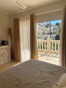 Schlafzimmer mit einem Bett und Blick auf einen Balkon in der Unterkunft Luxury B&B Villa Tauro in Málaga