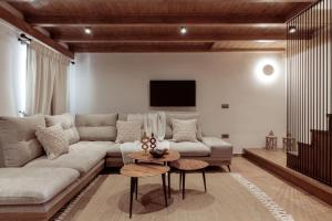 a living room with a couch and a tv at Villa Frontale in Kallithea