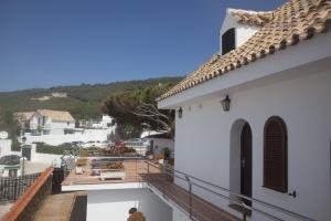 a balcony of a white building with a view of a street at Hostal Mar de Frente in Los Caños de Meca
