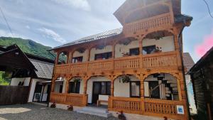 a large wooden building with a tower on top at La Mona in Bîrsana