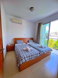 a bedroom with two beds and a large window at 3 Bedroom Coral Bay Beach Seaview Villa I Private Pool in Peyia