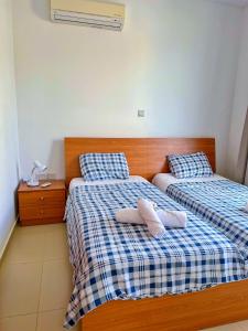 two beds in a bedroom with two towels on them at 3 Bedroom Coral Bay Beach Seaview Villa I Private Pool in Peyia