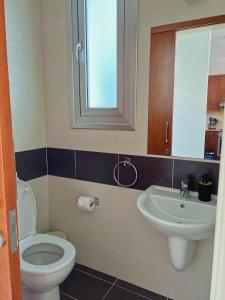 a bathroom with a toilet and a sink at 3 Bedroom Coral Bay Beach Seaview Villa I Private Pool in Peyia