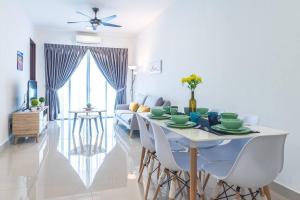 a dining room and living room with a table and chairs at Simfoni Tower 3R2B 8pax @C180@Chr Trader Square in Seri Kembangan