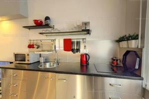 a kitchen with a sink and a counter top at Velnök Luxus Apartman in Makó