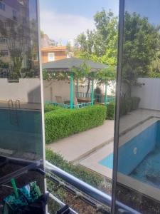 a view of a swimming pool from a window at Konyaaltı Denize Yakın Kiralık Daire in Antalya