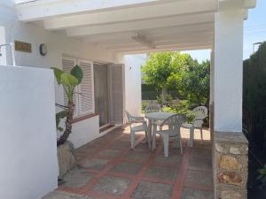 a patio with a table and chairs on it at VILLA MARIBEL in Calafat