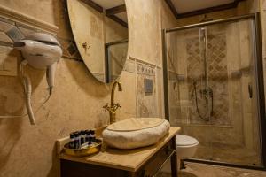 a bathroom with a shower and a toilet and a sink at Sobek Stone House Cappadocia in Nevsehir
