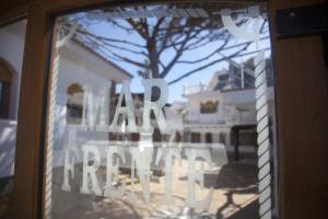 a glass window with the words real estate written on it at Hostal Mar de Frente in Los Caños de Meca