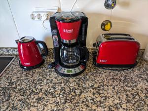 a red coffee maker and a toaster on a counter at Two Bedroom Apartment - 110m2, AC, Terrace, Wi-Fi in Lagos