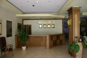 a waiting area in a hotel lobby with a reception desk at Aparthotel Regina Mare in Tsarevo +99 photos