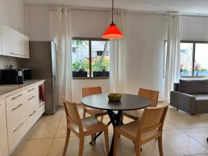 een keuken en eetkamer met een tafel en stoelen bij Roza Apartment in Tel Aviv