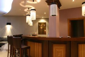 a bar in a restaurant with chairs and lights at Aparthotel Regina Mare in Tsarevo