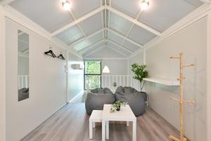 a living room with a table and a couch at Gate43 Garden Villa in Bangkok