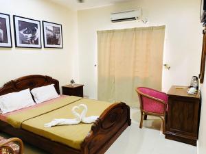 a bedroom with a bed with a towel on it at PD Lagoon Resort in Port Dickson