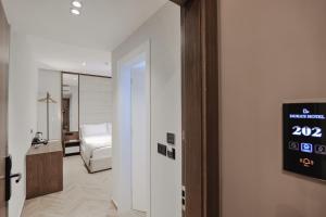 a hotel room with a bed and a clock on the wall at Duka's Hotel in Ksamil