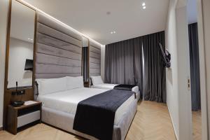 a hotel room with a large bed at Duka's Hotel in Ksamil