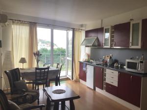 a kitchen and living room with a table and a dining room at Rose Apartment on the Beach in Byala