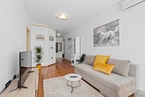a living room with a couch and a table at Feniks Fažana apartman in Fažana