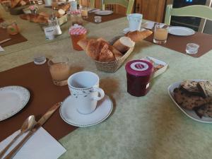 a table with a plate of bread and a cup of coffee at La Varenne in Monthou-sur-Cher