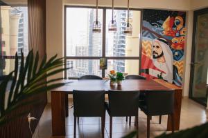 a dining room with a table and chairs and a large window at Lunar Hostel in Dubai