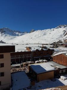 a snow covered mountain in front of a building at Superbe appart 6p Tignes Le LAC in Tignes