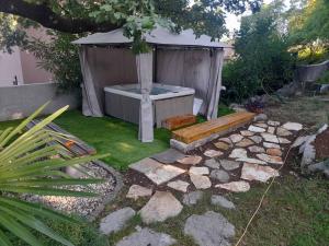 un jardín con bañera de hidromasaje y banco en Apartments Bosket, en Kastav