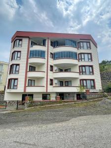 duży biały budynek z oknami na boku w obiekcie Parlayan Suite Trabzon w mieście Akcaabat
