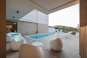 una casa con piscina e sedie bianche di Villa Fortunal a Murter