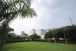 a building with a green lawn in front of a building at SHAKTI VILLA HOME STAY in Agra
