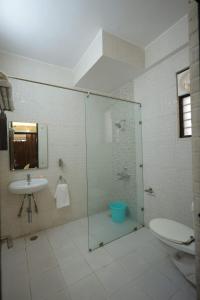 a bathroom with a shower and a toilet and a sink at SHAKTI VILLA HOME STAY in Agra