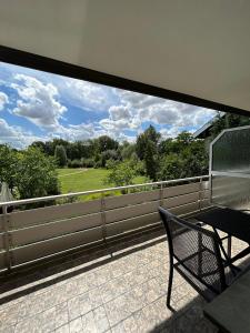 a balcony with a bench and a view of a field at Kurhotel Haus am Park in Erwitte