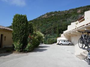 a car parked in a parking lot next to a building at Studio Le Lavandou, 1 pièce, 2 personnes - FR-1-308-183 in Le Lavandou