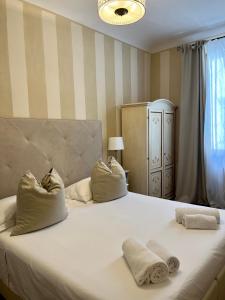 a bedroom with a large white bed with two pillows at Soggiorno Pezzati in Florence